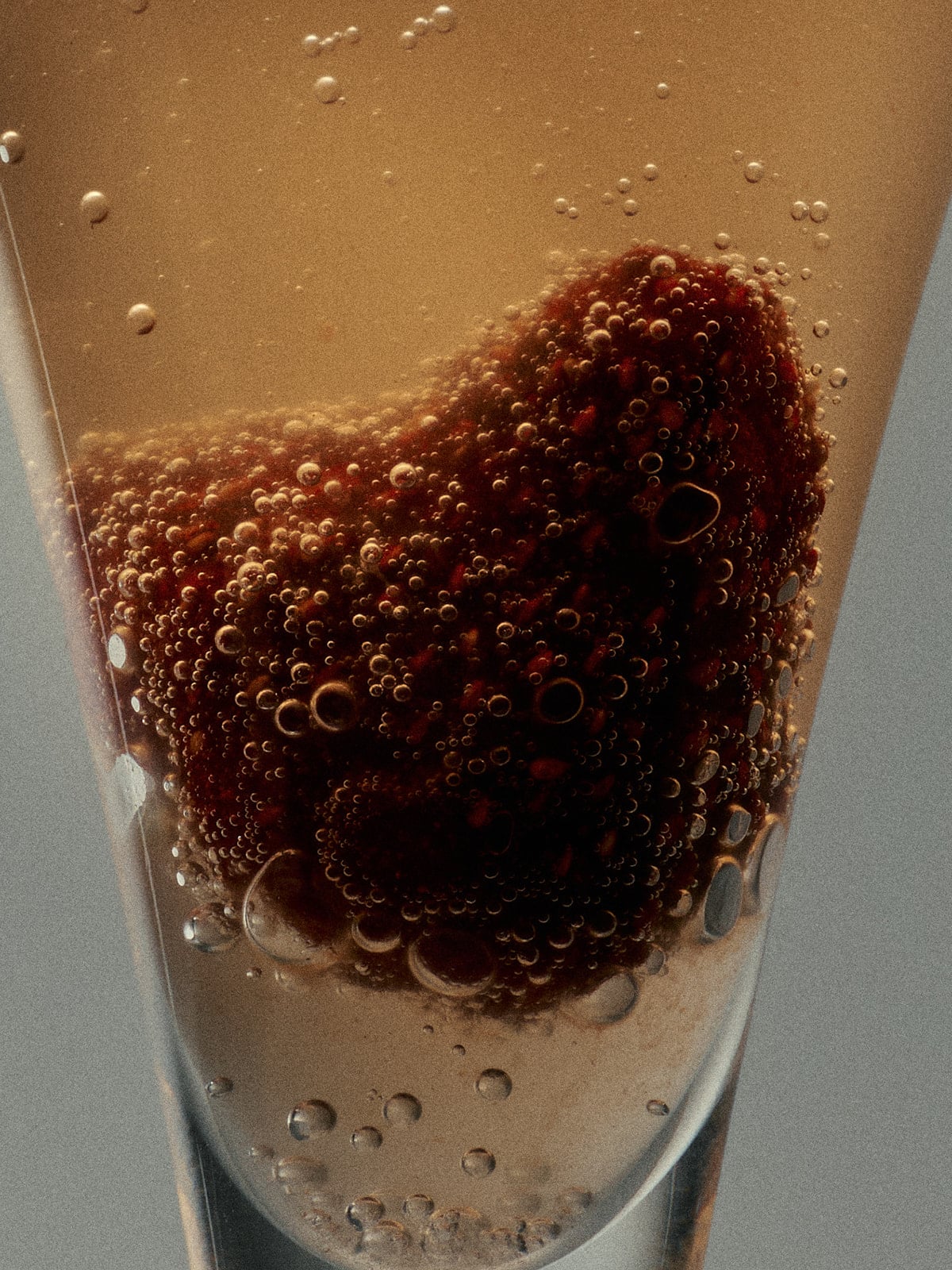 A Close Up of Flamingo Estate Spicy Strawberry Fruit Snack in Liquid Surrounded by Bubbles