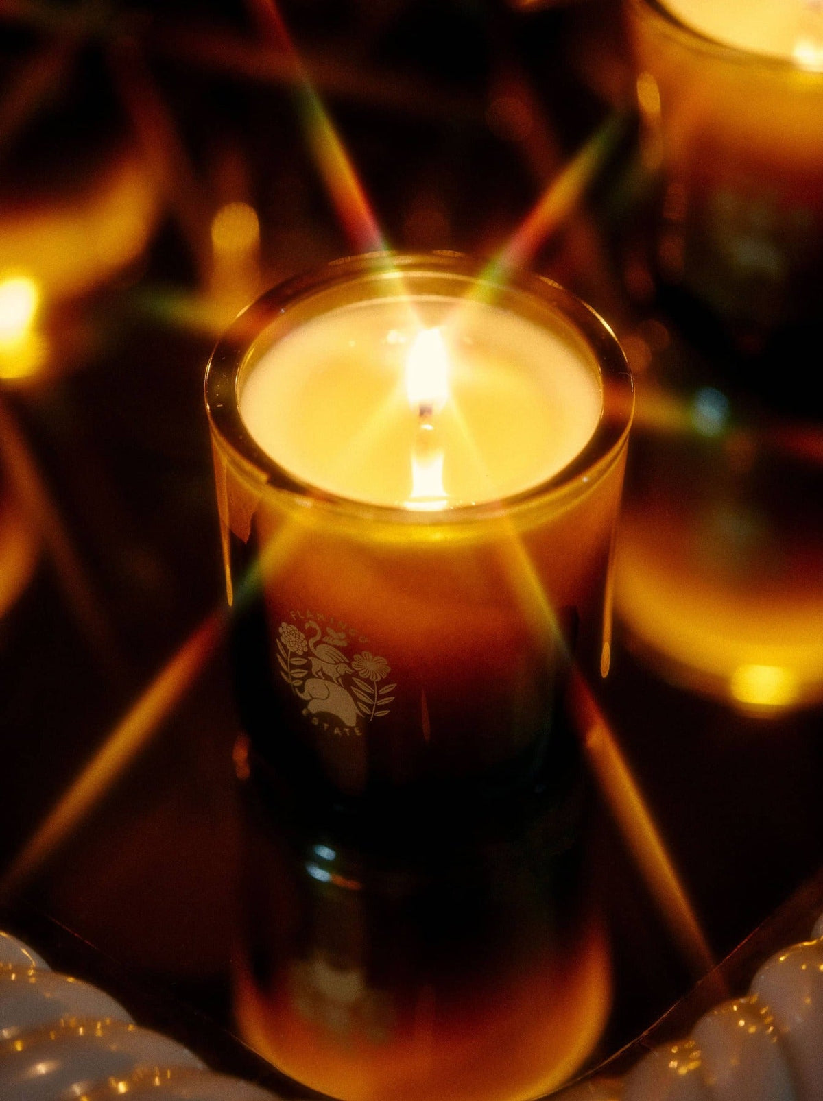 Sage Candle burning with a warm glow, highlighting its calming, aromatic quality.
