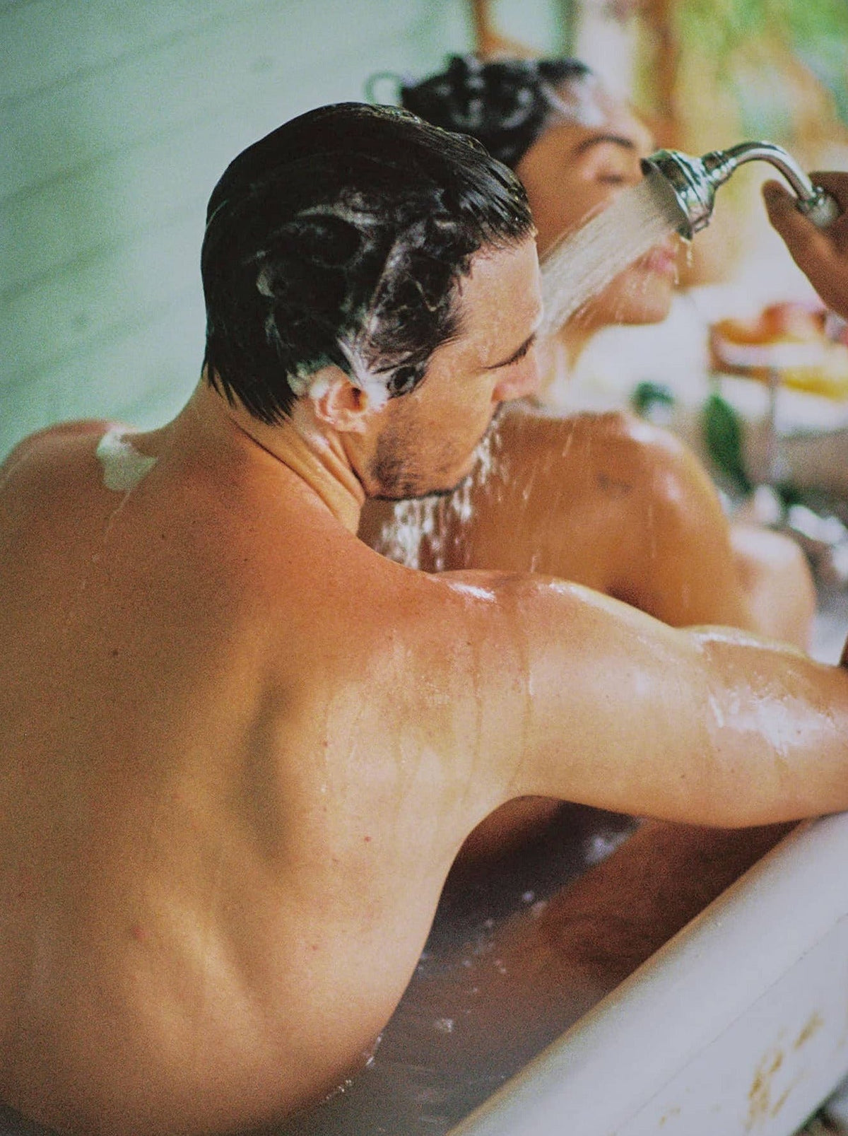 Man And Woman Showering Together In A Bathtub