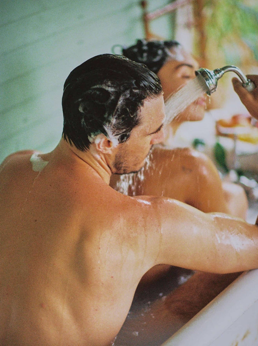 Man And Woman Showering Together In A Bathtub