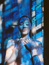 Woman Showering In A Setting Of Blue-Hued Lighting