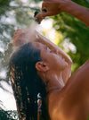 Woman Showering Outdoors With A Garden Hose