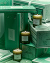 Sage Candle surrounded by other candles, illustrating a warm, ambient display.