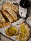 Extra Virgin Olive Oil and bread on a marble table