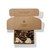 A cardboard box is open, revealing various mushrooms inside.