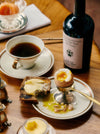 Dippy Egg With Toast And Butter, A Coffee, And A Bottle Of Flamingo Estate Heritage Extra Virgin Olive Oil