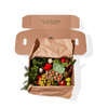 Box containing fresh produce and eggs placed on brown paper.